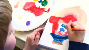 image of child painting with Artingales