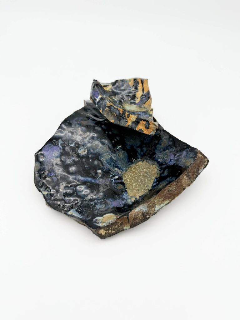 Adelina Ruvalcaba's ceramic sculpture "Our Cyclic Phases." Shards of broken pottery with emotive dark glaze.